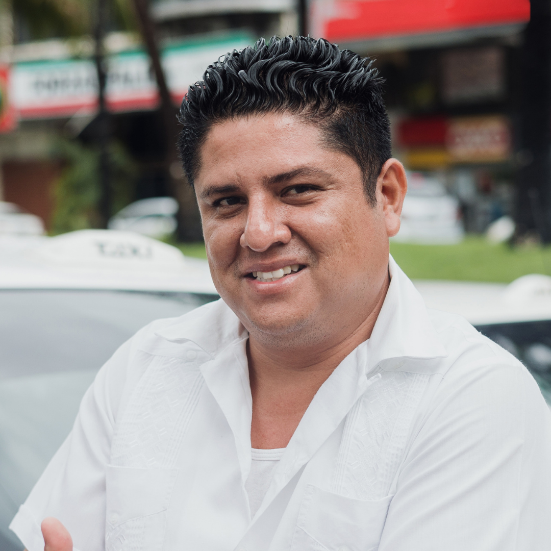 side face of a black man smiling in a light blue background