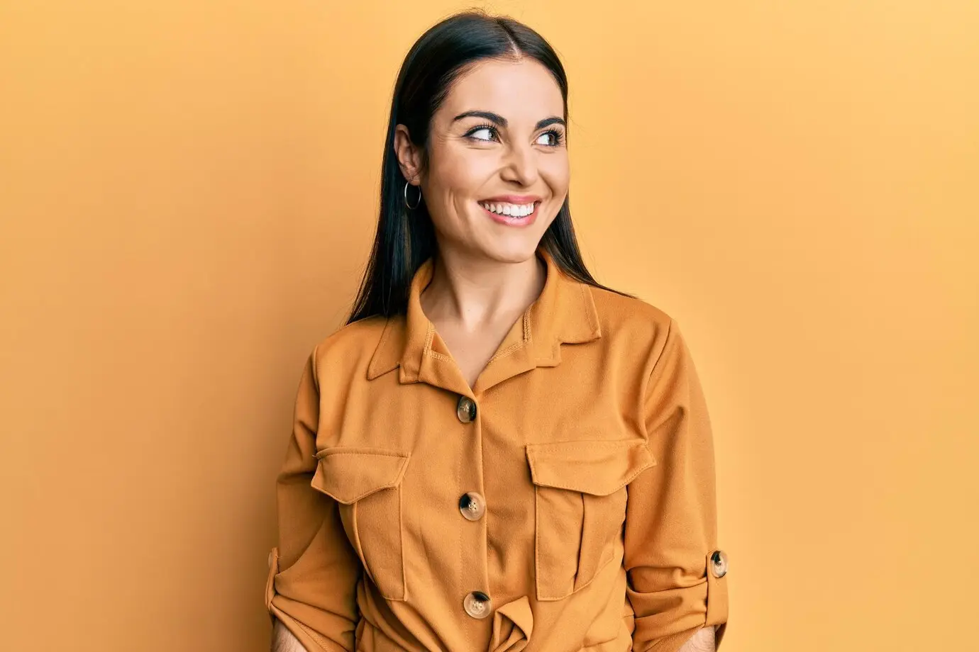 Woman smiling in a yellow background